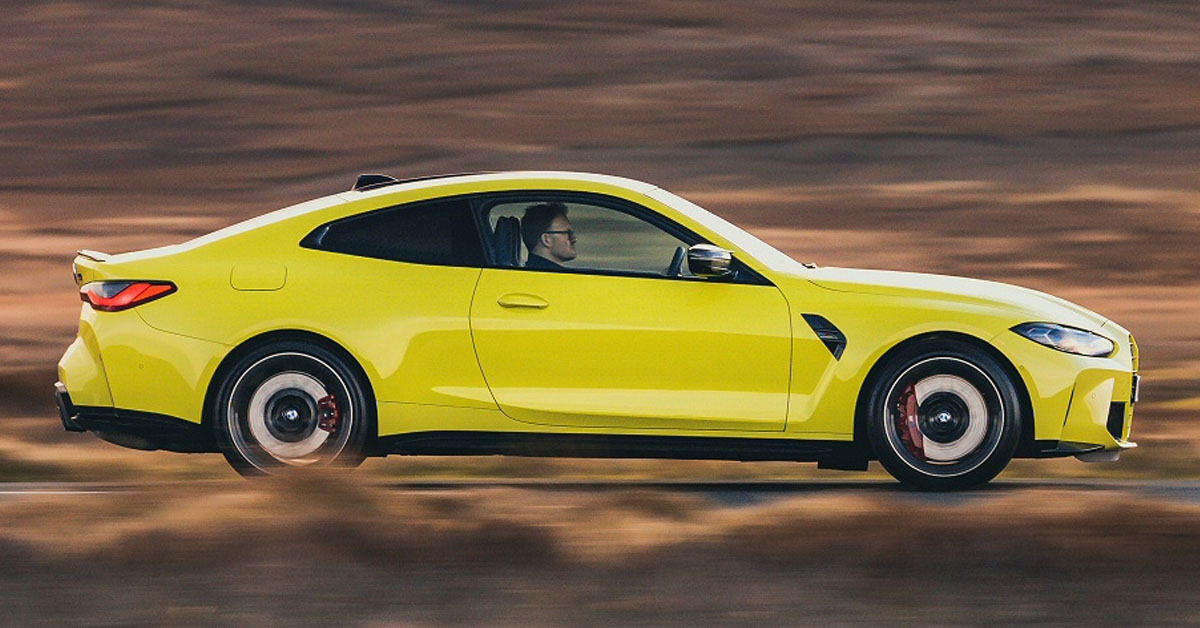 An image of a 2022 BMW M4 Coupe from the side profile