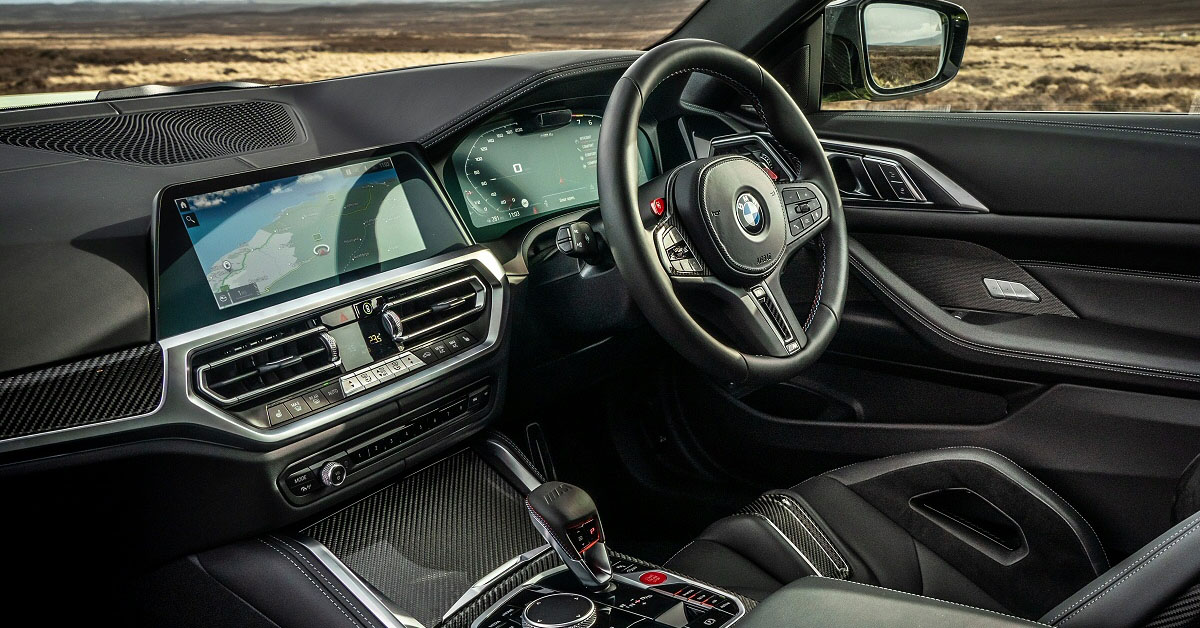 An image of a 2022 BMW M4 Coupe interior showing the steering wheel