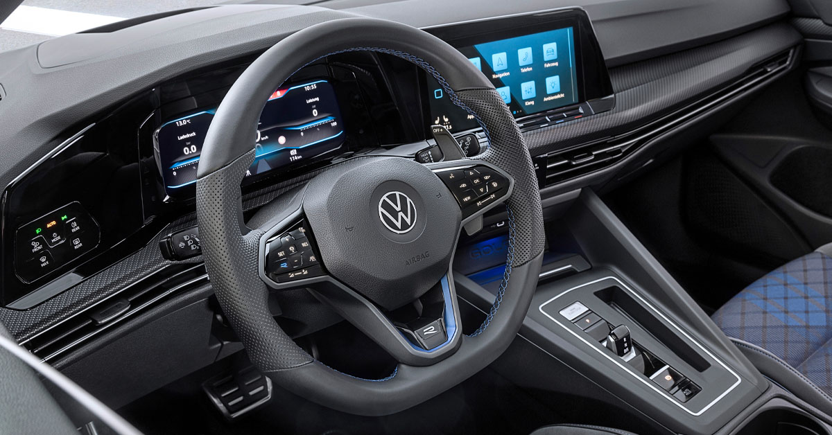 An image of the 2022 Volkswagen Golf R Estate with a close up of the steering wheel and dashboard