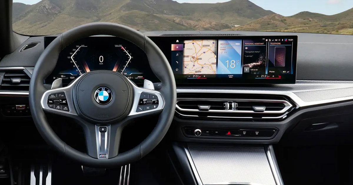 An image of the new 2022 BMW 3 Series Saloon interior dashboard showing the touchscreen and steering wheel