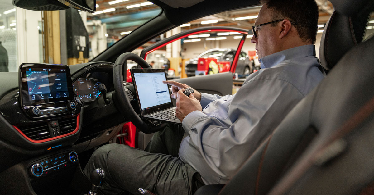 A picture of a Ford employee configuring a Ford keyless fob