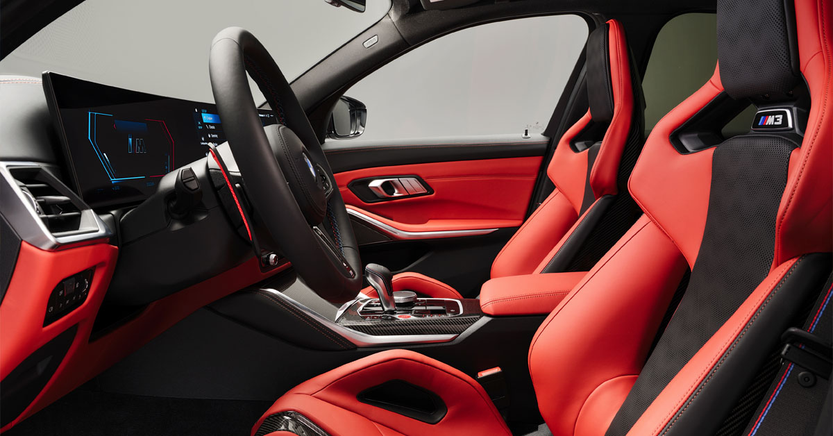 An image of the 2022 BMW M3 Competition Touring xDrive interior front section taken from the front driver door point of view