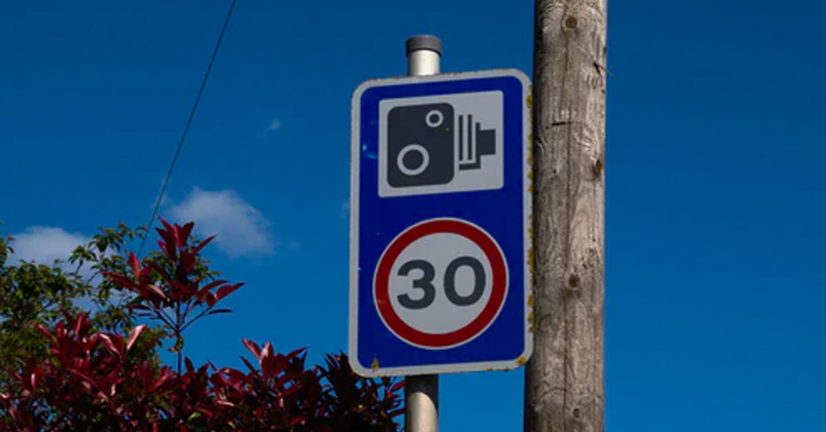 Sign warning of upcoming speed camera and 30mph speed limit